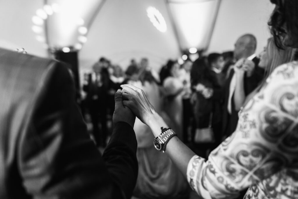 man woman hold their hands up while dancing